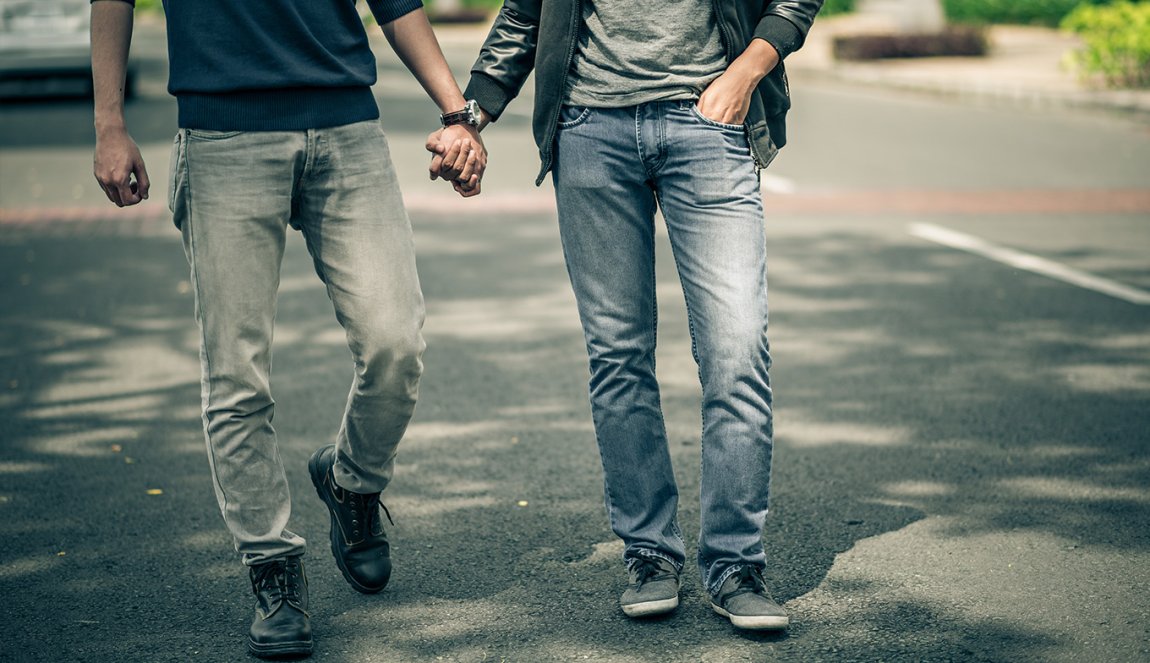 Men walking hand in hand on the street
