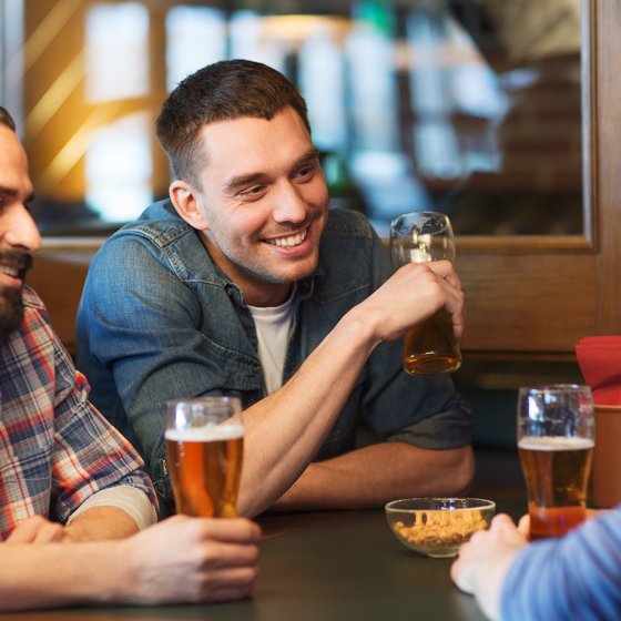 Male friends drinking beer at the pub