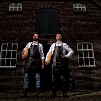 Father and son in front of De Groote Voort farm in the Gelderse Vallei with Remeker cheese
