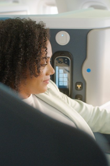 Business traveller seated in a KLM World Business Class seat during a flight