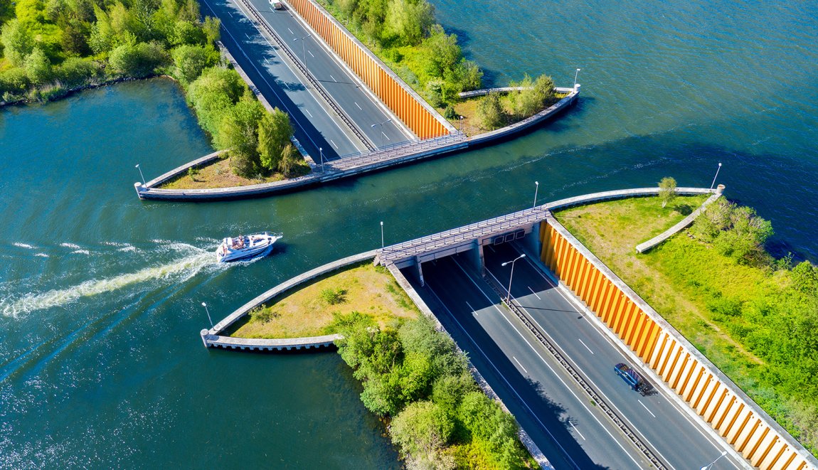 Aquaduct Veluwemeer, aerial view from the drone. A sailboat sails through the aqueduct on the lake above the highway.