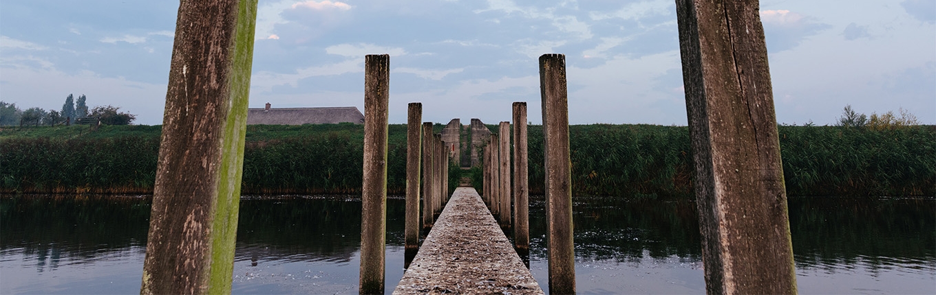 Hollandse Waterlinie jetty with wooden posts to bunker on Diefdijk Hollandse Waterlinie jetty with wooden posts to bunker on Diefdijk