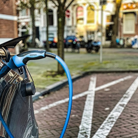 Electric car is parked in a residential dutch street and is being charged The Hague