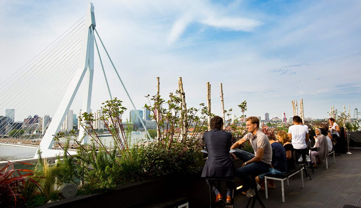 TGuests on the terrace of nhow hotel - view of Erasmus Bridge