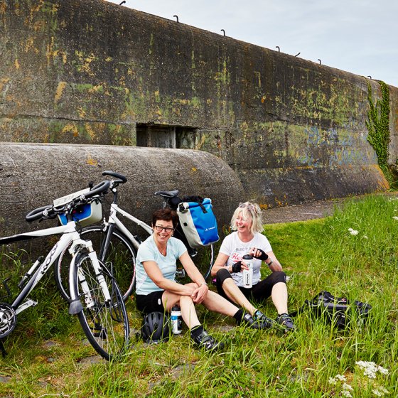 Cyclists take a break at the bunker on the Afsluitdijk