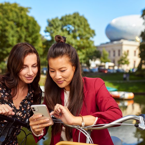 Ladies with mobile in front of the Fundatie in Zwolle Hanseatic cities
