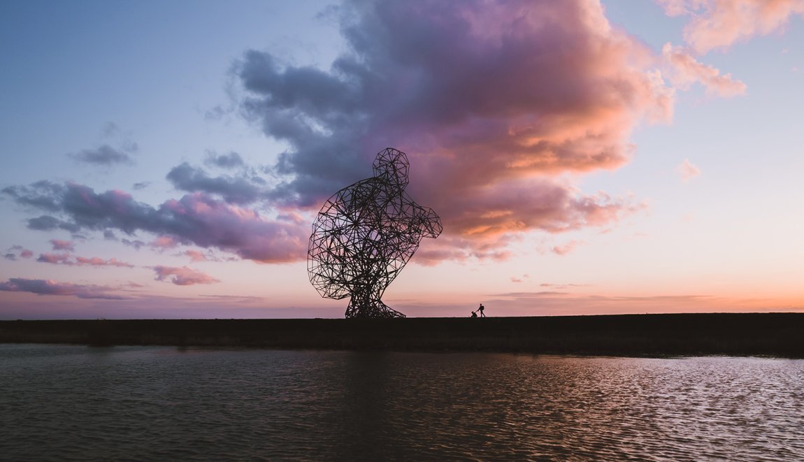 Land Art Exposure by artist Gormley with explosive skies Land Art Exposure by artist Gormley with explosive skies