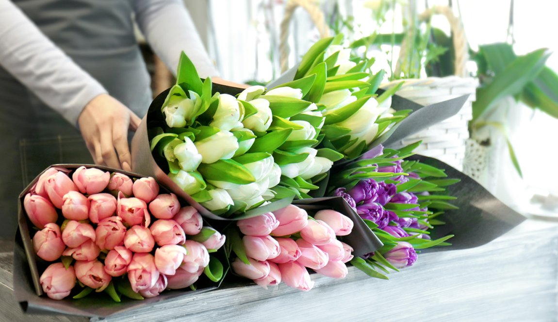 Florist with beautiful bouquets in flower shop