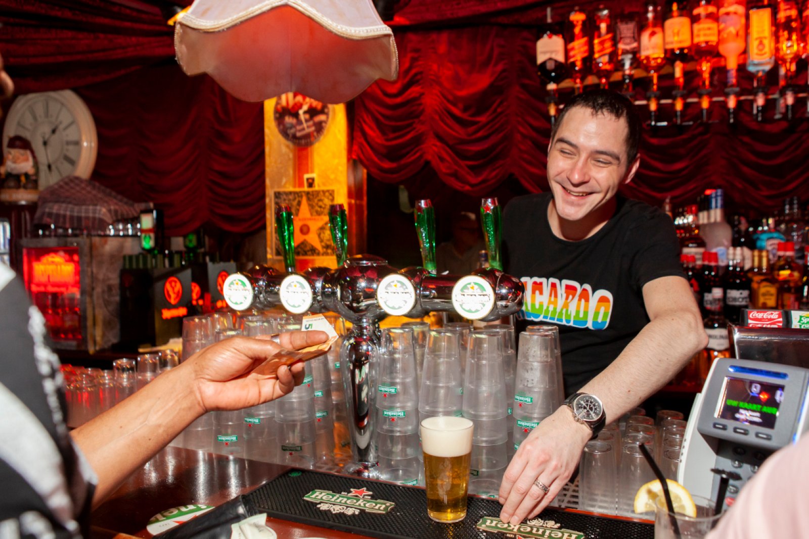 Bartender serves beer in gay bar Rotterdam