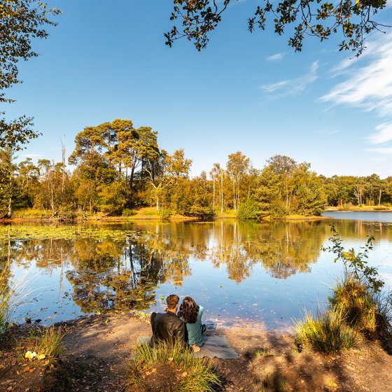 Oisterwijk lake in autumn with couple by the water