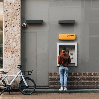Lady parked her bike to withdraw money at Geldmaat (Dutch ATM)