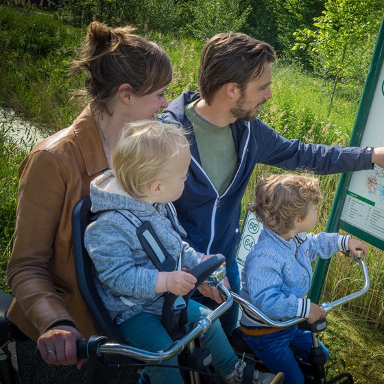 Family looks at sign cycling route network Central Friesland