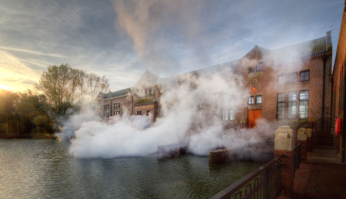 Woudagemaal pumping station with steam coming out of the building