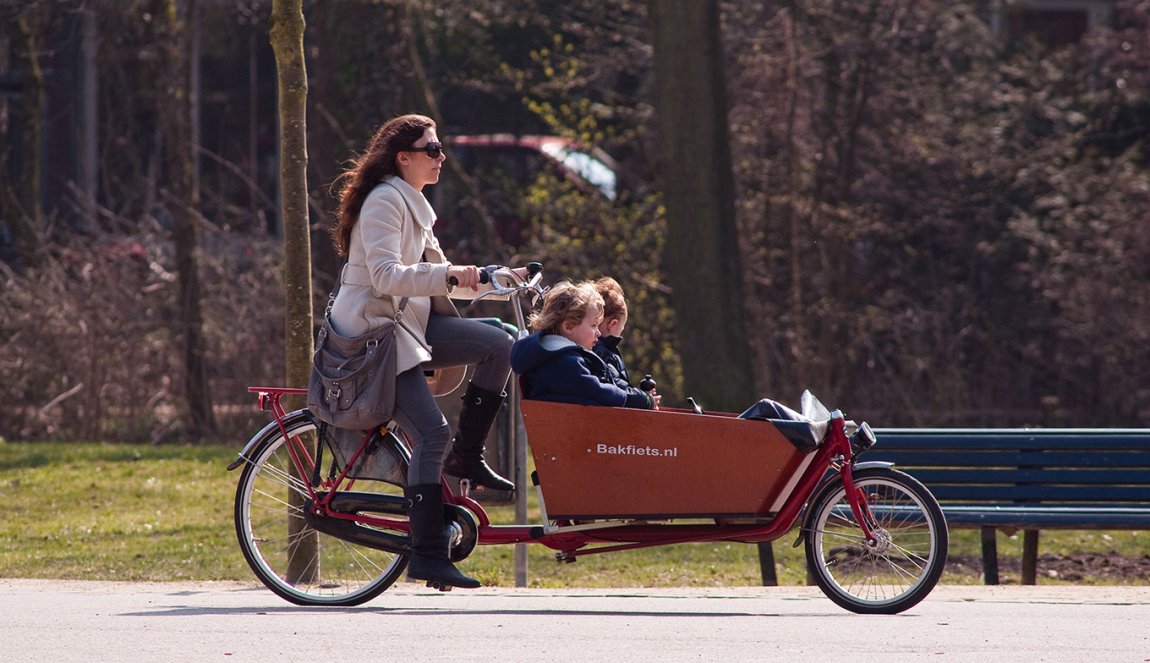 Mother with children in the cargo bike Mother with children in the cargo bike