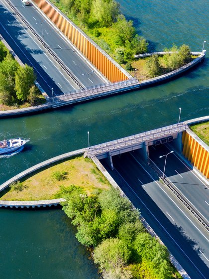 Aquaduct Veluwemeer, aerial view from the drone. A sailboat sails through the aqueduct on the lake above the highway.