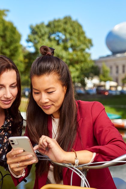 Ladies with mobile in front of the Fundatie in Zwolle Hanseatic cities