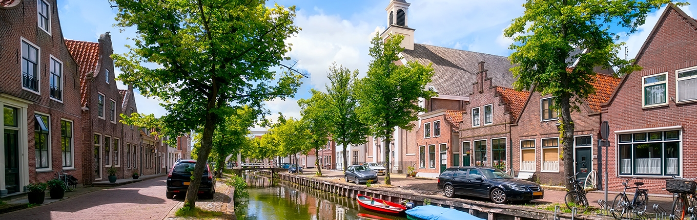 Edam houses canal with boats Edam houses canal with boats