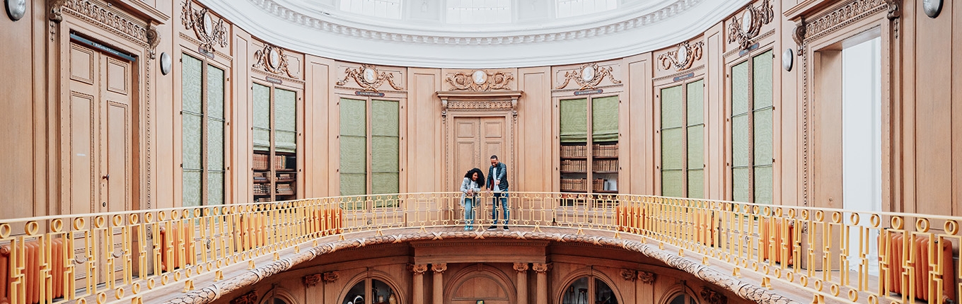 Couple looking down from balustrade Teylers Museum Haarlem Couple looking down from balustrade Teylers Museum Haarlem