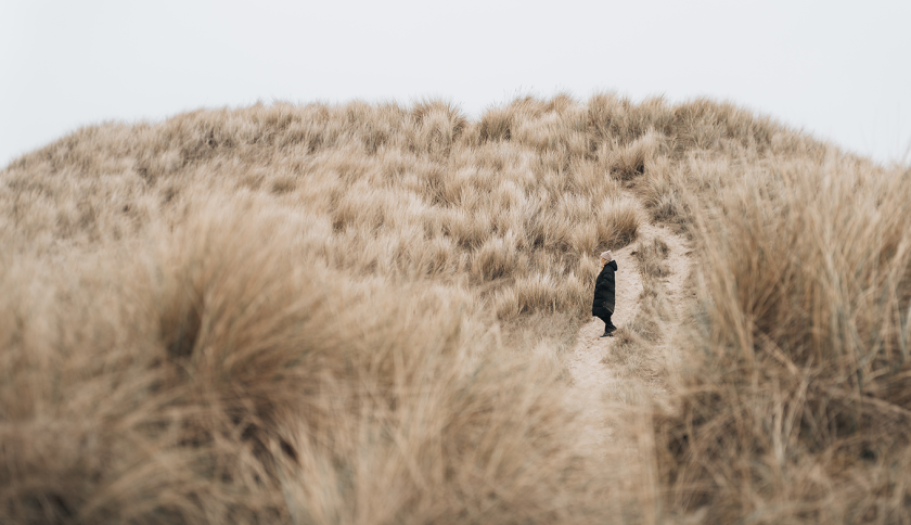 Woman standing in the dunes 