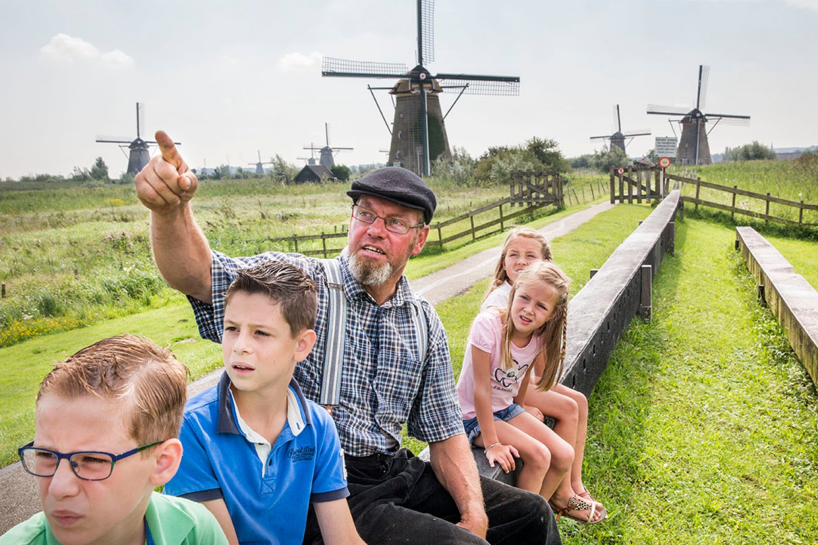Kids looking at windmills miller tour at kinderdijk