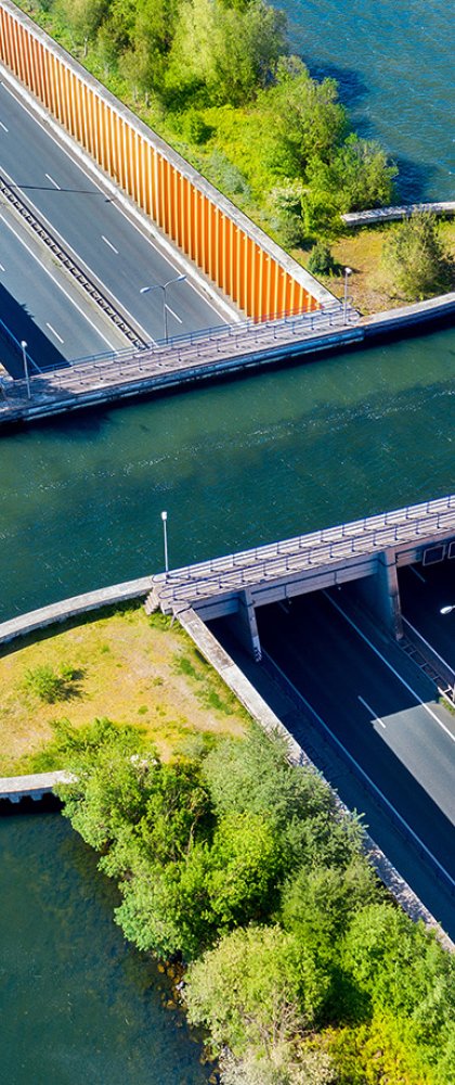 Aquaduct Veluwemeer, aerial view from the drone. A sailboat sails through the aqueduct on the lake above the highway.