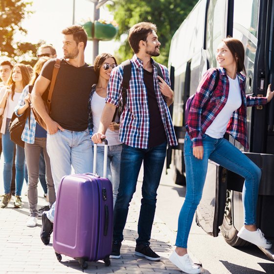 Group of travellers board bus
