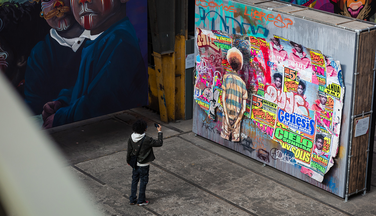 Man takes photo of street art in the STRAAT Museum on the NDSM site in Amsterdam