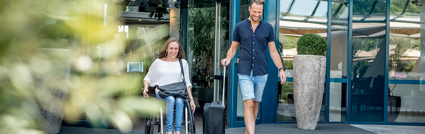 Couple after visiting Sanadome Hotel & Spa Nijmegen. Lady is in a wheelchair. Couple after visiting Sanadome Hotel & Spa Nijmegen. Lady is in a wheelchair.