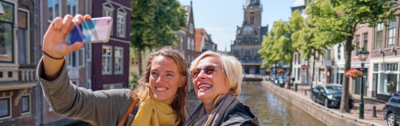 Two women making selfie on bridge in Alkmaar 