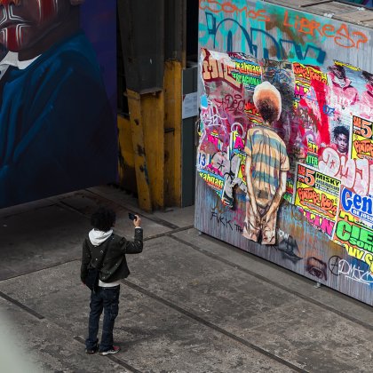Man takes photo of street art in the STRAAT Museum on the NDSM site in Amsterdam