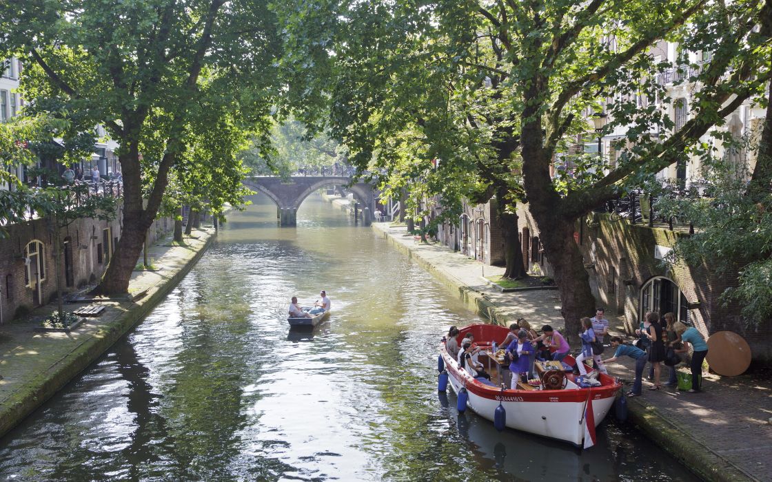 People get on boat in Oude Gracht (Old Canal) in Utrecht People get on boat in Oude Gracht (Old Canal) in Utrecht