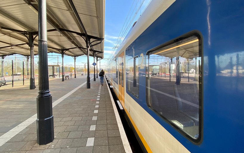 Someone walks to the train at NS station Geldermalsen