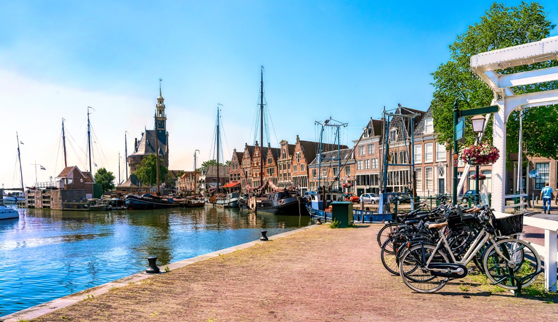 Harbor of Hoorn with the Hoofdtoren, sailboats and city buildings Harbor of Hoorn with the Hoofdtoren, sailboats and city buildings