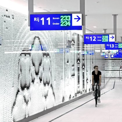 Cyclist bike through bike parking lot Koningin Julianaplein The Hague designed bij Silo