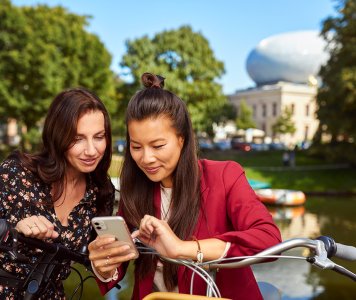 Ladies with mobile in front of the Fundatie in Zwolle Hanseatic cities