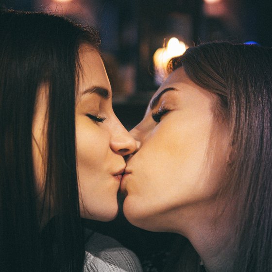 Women with brown hair kissing
