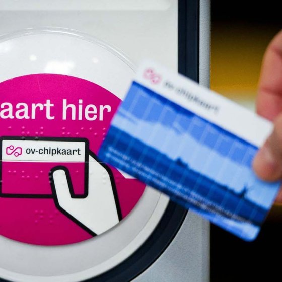 Hand with OV-chip card for entrance gate NS