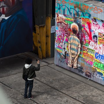 Man takes photo of street art in the STRAAT Museum on the NDSM site in Amsterdam
