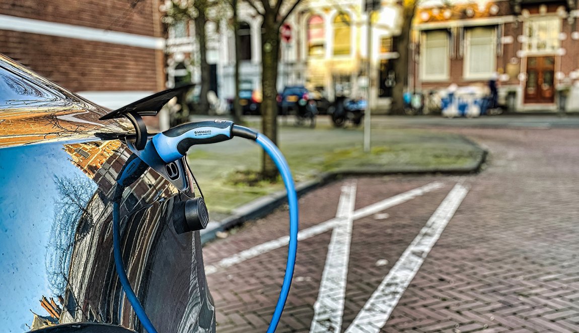 Electric car is parked in a residential dutch street and is being charged The Hague
