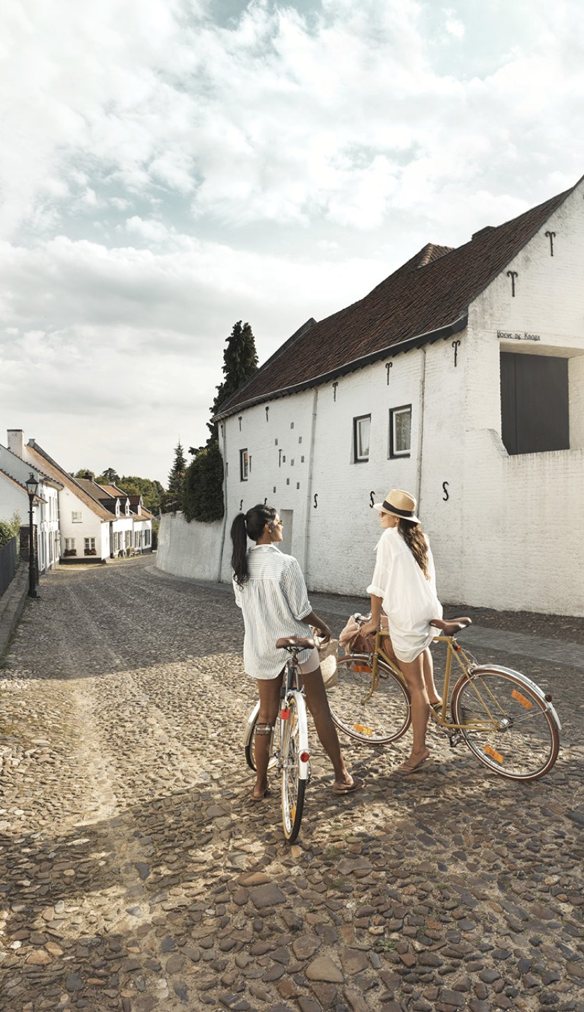 Two ladies on bikes in a street in Thorn 