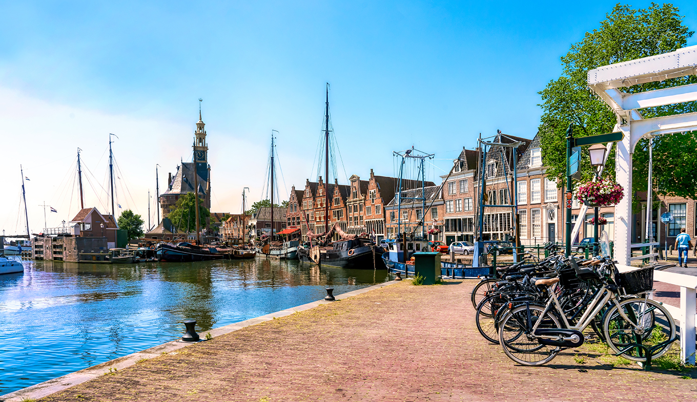 Harbor of Hoorn with the Hoofdtoren, sailboats and city buildings Harbor of Hoorn with the Hoofdtoren, sailboats and city buildings