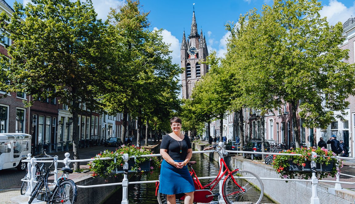 Melissa Bruntlett with bike at the canal Oude Delft backdrop The Old Church