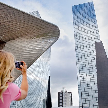 Lady takes picture of Delftse Poort in Rotterdam