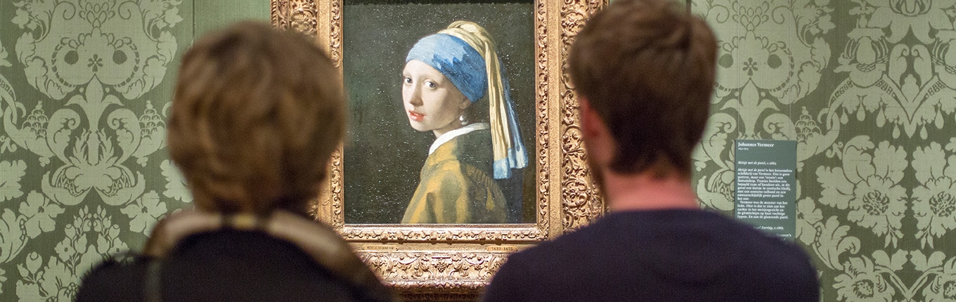 Visitors view painting Girl with a Pearl Earring part of the Mauritshuis collection 