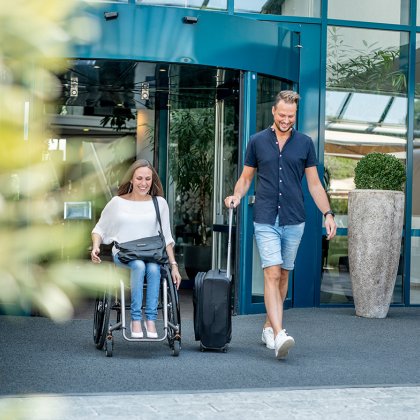 Couple after visiting Sanadome Hotel & Spa Nijmegen. Lady is in a wheelchair.