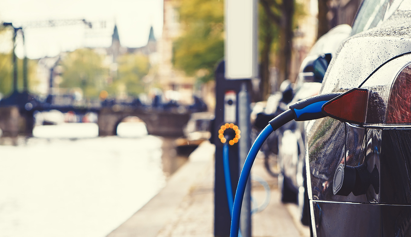 Electric car charging in the street of Amsterdam Electric car charging in the street of Amsterdam
