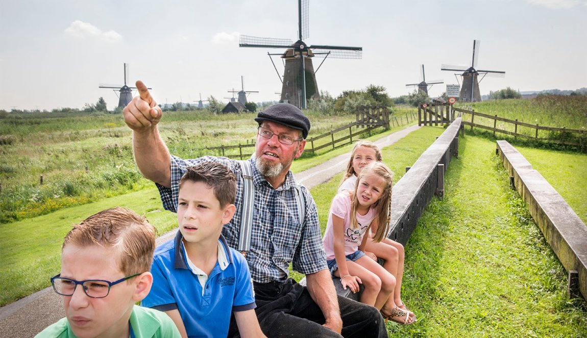 Kids looking at windmills miller tour at kinderdijk
