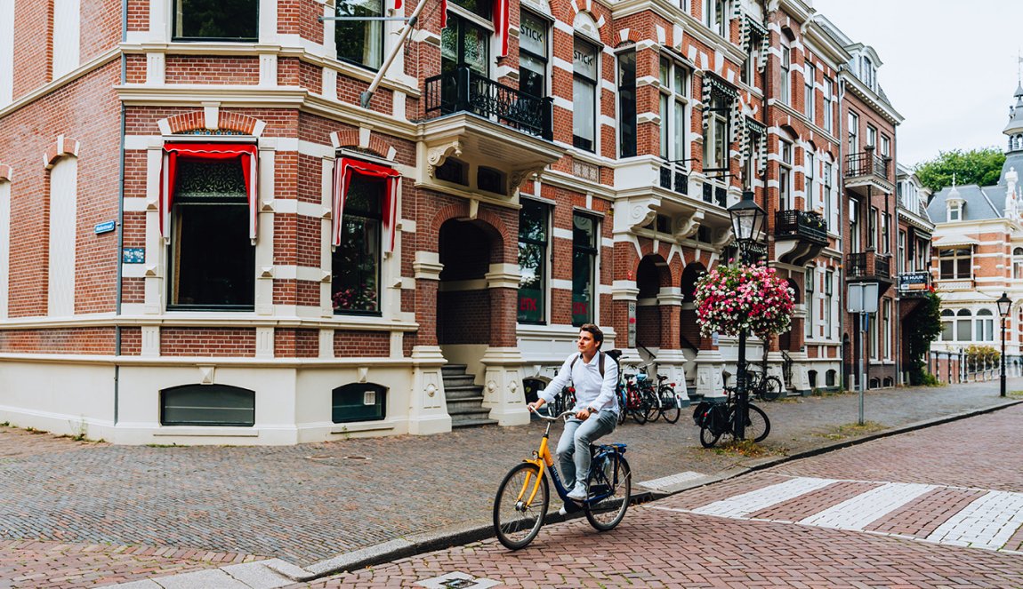 Utrecht Maliebaan cyclist with old facade buildings
