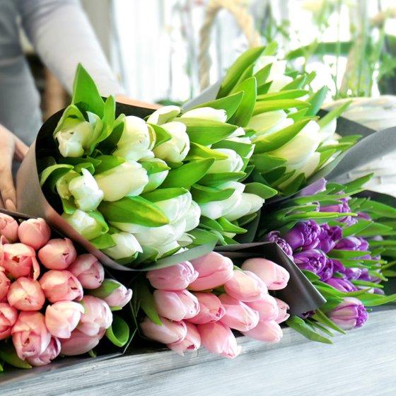 Florist with beautiful bouquets in flower shop