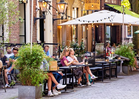 People on terraces at Mariaplaats in Utrecht People on terraces at Mariaplaats in Utrecht